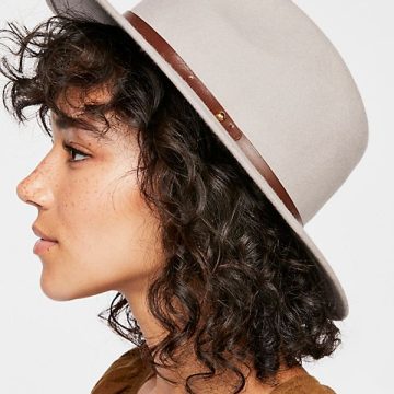 wear a hat with short curly hair
